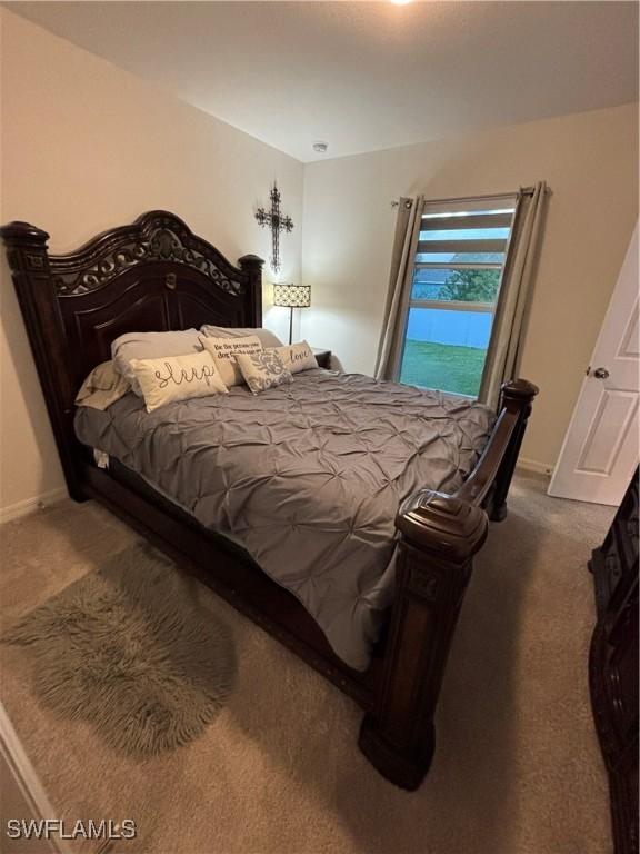 bedroom with baseboards and carpet floors