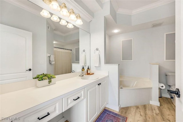 bathroom with visible vents, a garden tub, ornamental molding, wood finished floors, and vanity