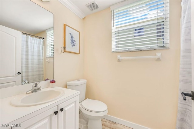 bathroom with visible vents, toilet, wood finished floors, baseboards, and vanity