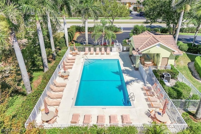 community pool featuring a patio and fence