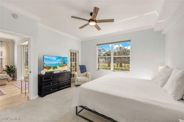 bedroom with carpet flooring, a ceiling fan, crown molding, and baseboards