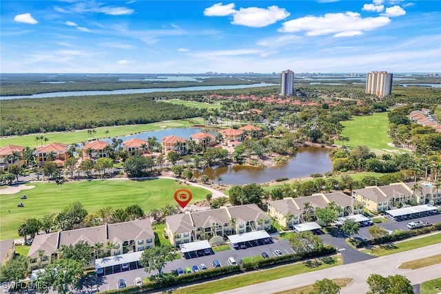 birds eye view of property with golf course view, a water view, and a residential view