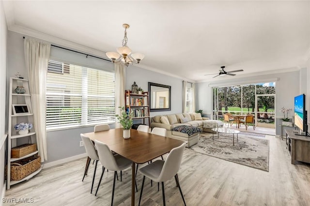 dining space featuring baseboards, light wood-style floors, ornamental molding, and ceiling fan with notable chandelier