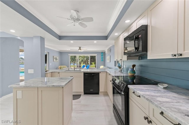 kitchen featuring crown molding, ceiling fan, a tray ceiling, a peninsula, and black appliances