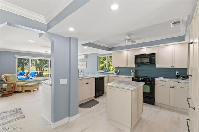 kitchen with visible vents, ceiling fan, ornamental molding, black appliances, and a center island