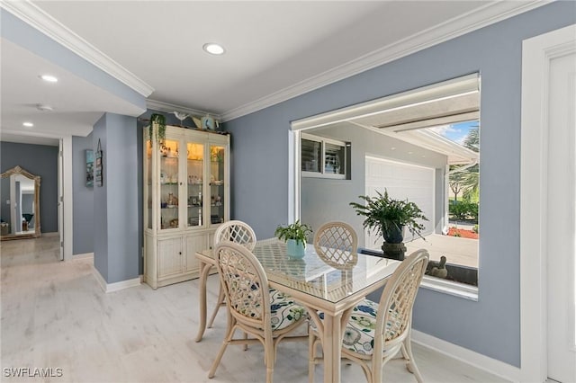 dining room featuring recessed lighting, baseboards, light wood finished floors, and ornamental molding