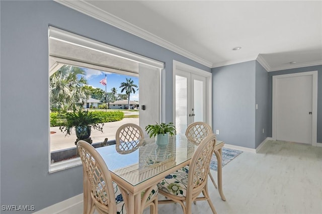 dining space with french doors, baseboards, and ornamental molding