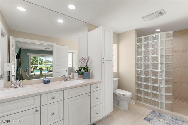 bathroom with tile patterned flooring, visible vents, toilet, and a sink