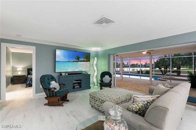 living room featuring visible vents, wood finished floors, and ornamental molding