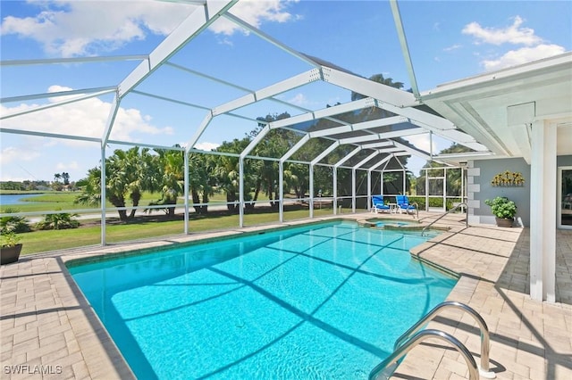 view of pool with a lanai, a patio area, and a pool with connected hot tub