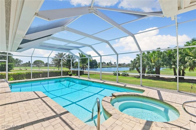 view of swimming pool with a pool with connected hot tub, a water view, glass enclosure, a yard, and a patio