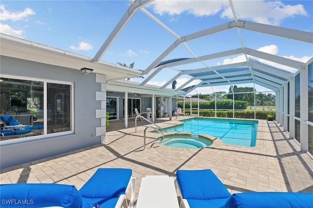 outdoor pool with a patio area, glass enclosure, and an in ground hot tub