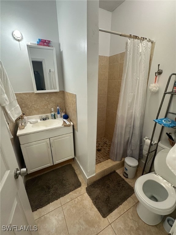 full bath with tile patterned floors, toilet, a stall shower, tasteful backsplash, and vanity