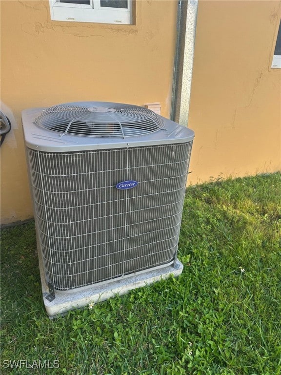 exterior details featuring central AC unit and stucco siding