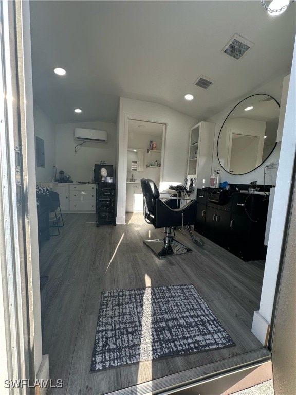 bathroom with an AC wall unit, recessed lighting, wood finished floors, and visible vents