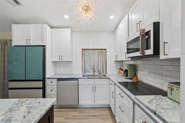 17450 Taylor Rd, Alva, FL 33920 - kitchen featuring a sink, dishwasher, white cabinets, and refrigerator