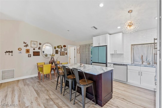 17450 Taylor Rd, Alva, FL 33920 - kitchen featuring visible vents, a sink, stainless steel dishwasher, fridge, and a chandelier