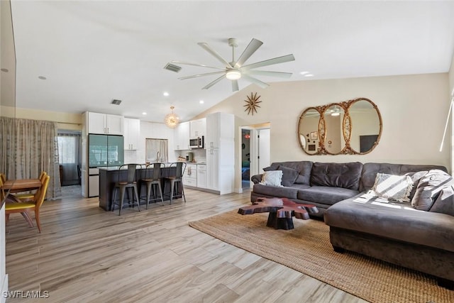 17450 Taylor Rd, Alva, FL 33920 - living area featuring visible vents, light wood-type flooring, a ceiling fan, and vaulted ceiling