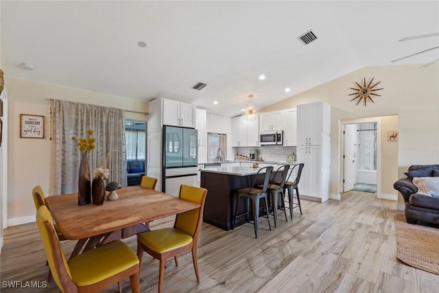 17450 Taylor Rd, Alva, FL 33920 - dining area with visible vents, lofted ceiling, baseboards, and light wood-style flooring