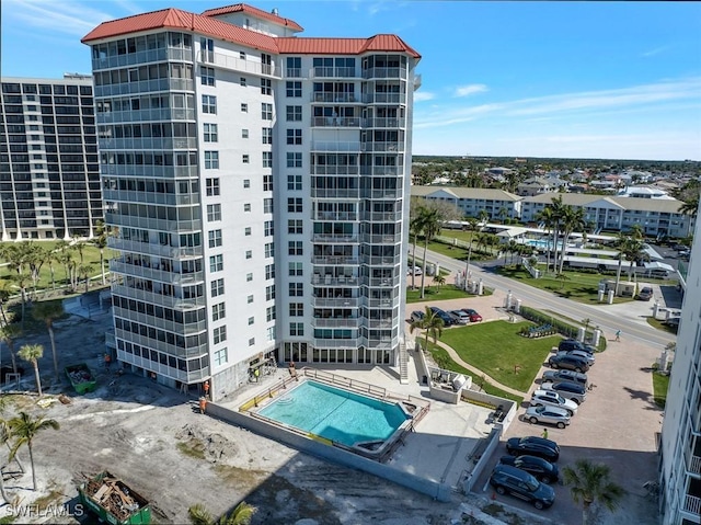 view of building exterior with a community pool