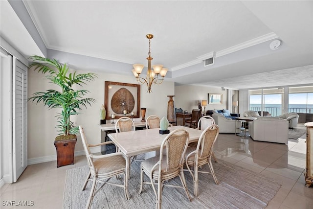 dining area with visible vents, crown molding, baseboards, light tile patterned floors, and a notable chandelier