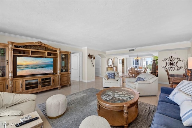 living room featuring visible vents, arched walkways, crown molding, light tile patterned floors, and baseboards