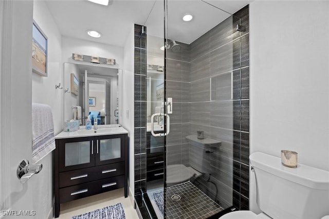 bathroom with recessed lighting, toilet, a stall shower, and vanity