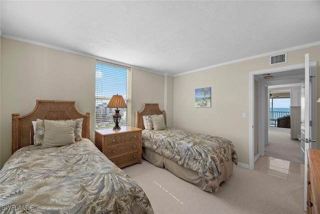 bedroom with visible vents, light colored carpet, baseboards, and ornamental molding