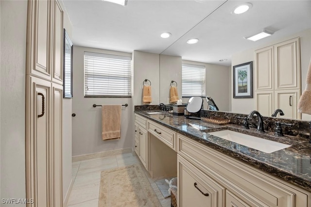 bathroom with tile patterned flooring, double vanity, recessed lighting, and a sink