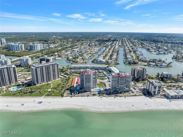 aerial view featuring a water view, a city view, and a view of the beach