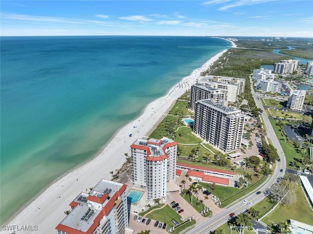 birds eye view of property featuring a water view, a view of city, and a view of the beach