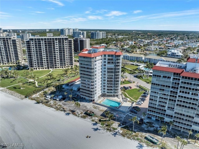 drone / aerial view featuring a city view and a water view