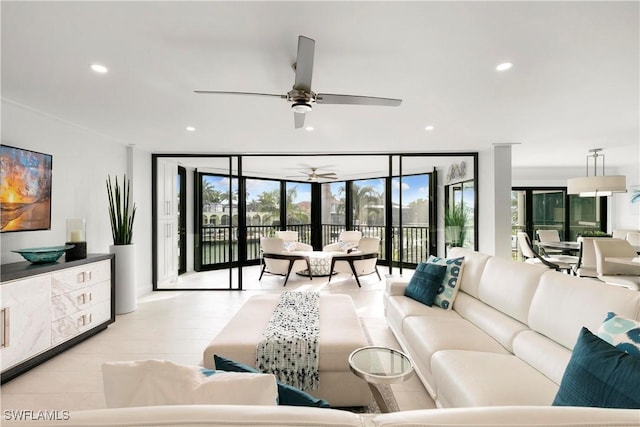 living room featuring a wall of windows, recessed lighting, and ceiling fan