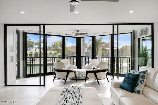 living room with recessed lighting, ceiling fan, and expansive windows