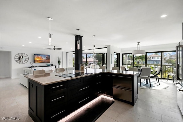 kitchen with pendant lighting, open floor plan, dark cabinetry, recessed lighting, and black electric cooktop