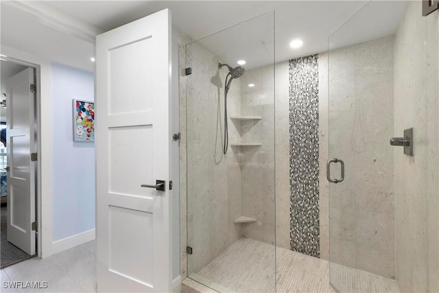 bathroom with tile patterned floors, baseboards, and a stall shower