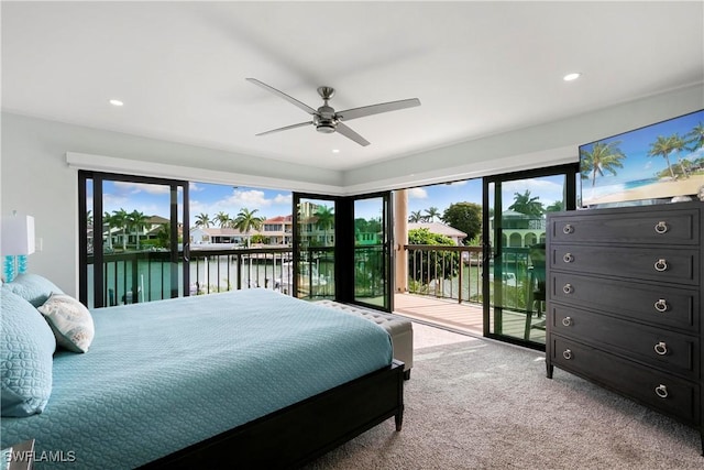 bedroom featuring carpet, a water view, recessed lighting, a ceiling fan, and access to outside