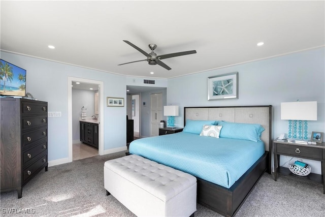 carpeted bedroom featuring visible vents, baseboards, recessed lighting, ensuite bathroom, and a ceiling fan