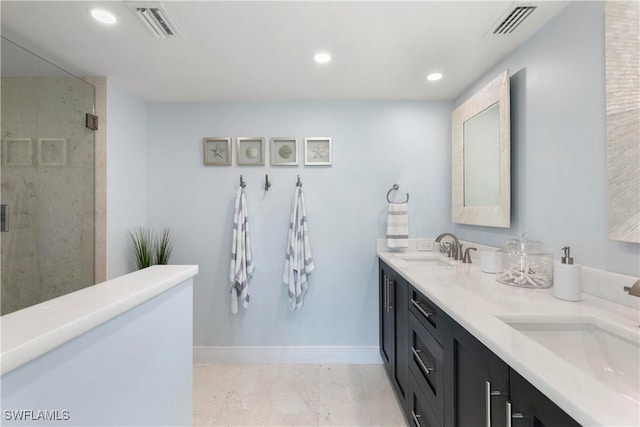 bathroom with a stall shower, visible vents, and a sink