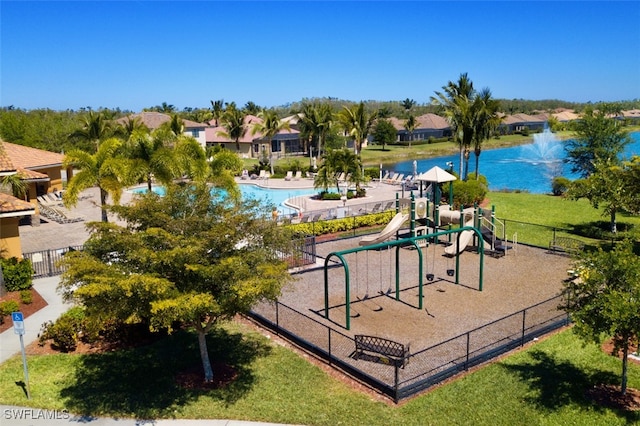 surrounding community featuring playground community, a water view, a lawn, and fence