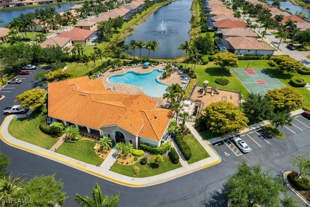 birds eye view of property with a water view