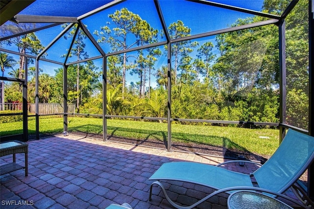 view of patio / terrace featuring glass enclosure