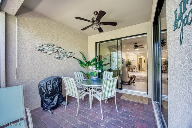 view of patio featuring outdoor dining area and ceiling fan