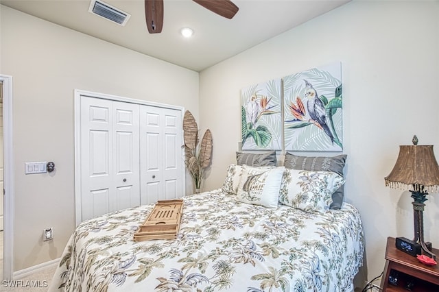 carpeted bedroom featuring visible vents, baseboards, a closet, and ceiling fan