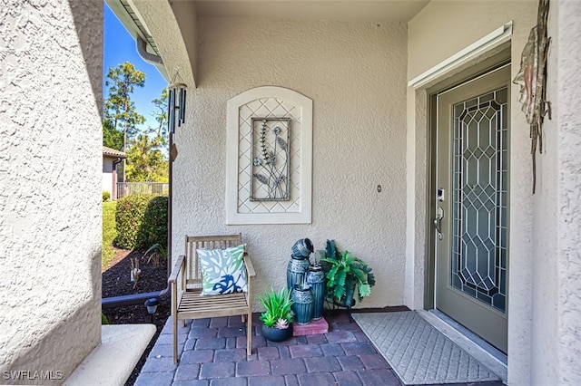 entrance to property with stucco siding