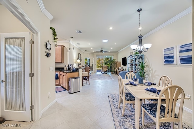 dining room featuring visible vents, crown molding, baseboards, light tile patterned flooring, and a ceiling fan