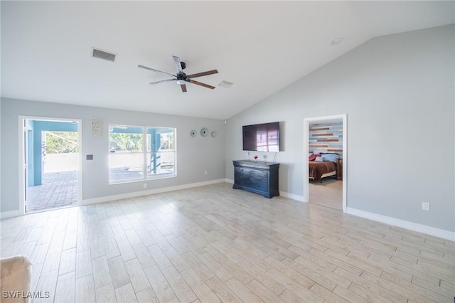 unfurnished living room with light wood-type flooring, visible vents, a ceiling fan, baseboards, and vaulted ceiling