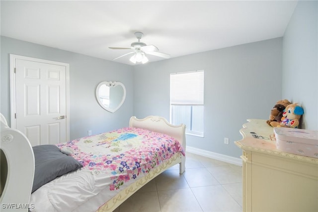 bedroom featuring light tile patterned flooring, a ceiling fan, and baseboards