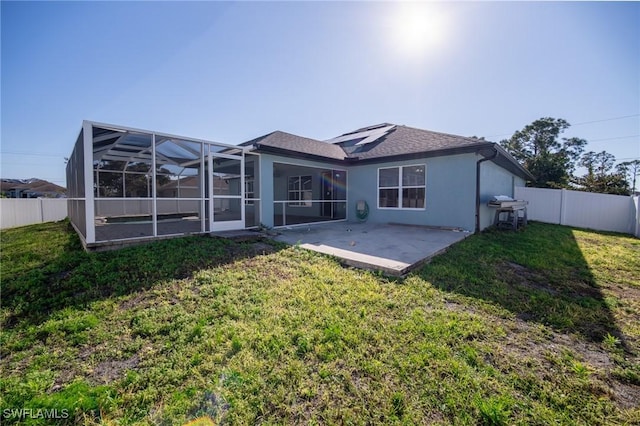 back of house featuring a yard, a patio, and a fenced backyard