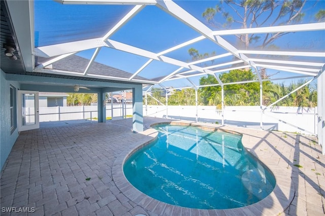 view of swimming pool with a patio area, a fenced in pool, glass enclosure, and a fenced backyard